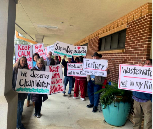 Protesters holding signs outside City Hall in Milton Fl to stop wastewater plan