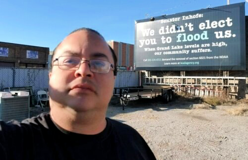 Lead Agency - Home page pic_CE Lead Agency member in front of sign in parking lot.