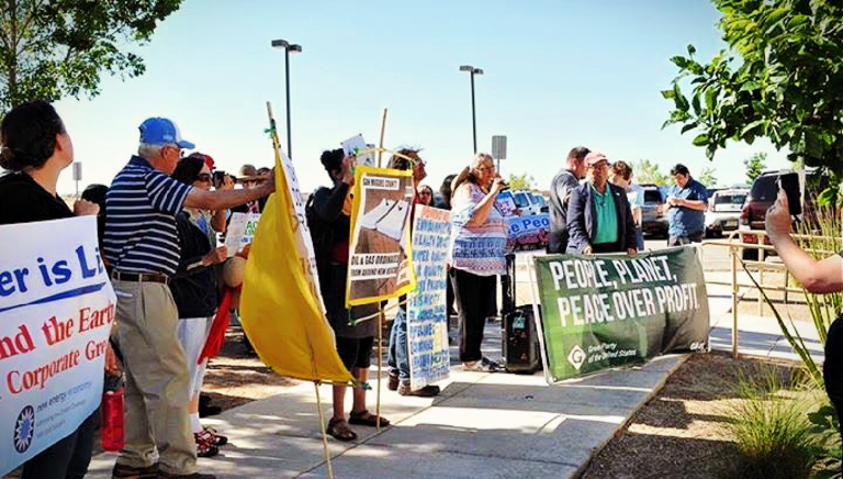 Common Ground Rising members protesting in public with signs